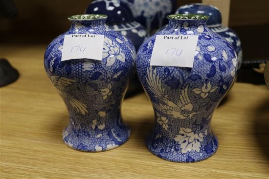 Three Oriental blue and white jars and covers, and a pair of vases